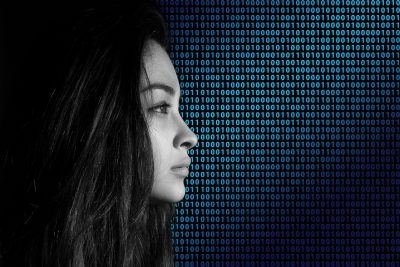 girl in front of binary code